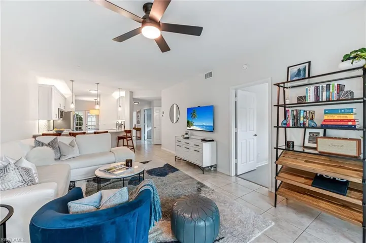 Tiled living room featuring ceiling fan