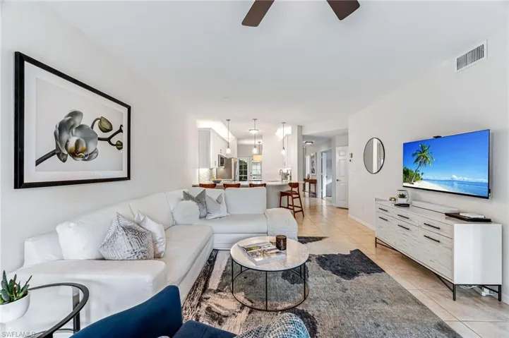 Living room featuring ceiling fan and light tile patterned floors