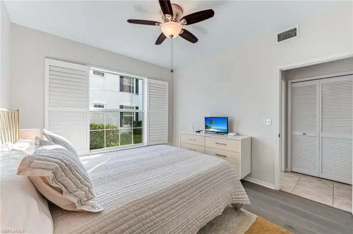 Bedroom featuring a closet, ceiling fan, and light hardwood / wood-style flooring
