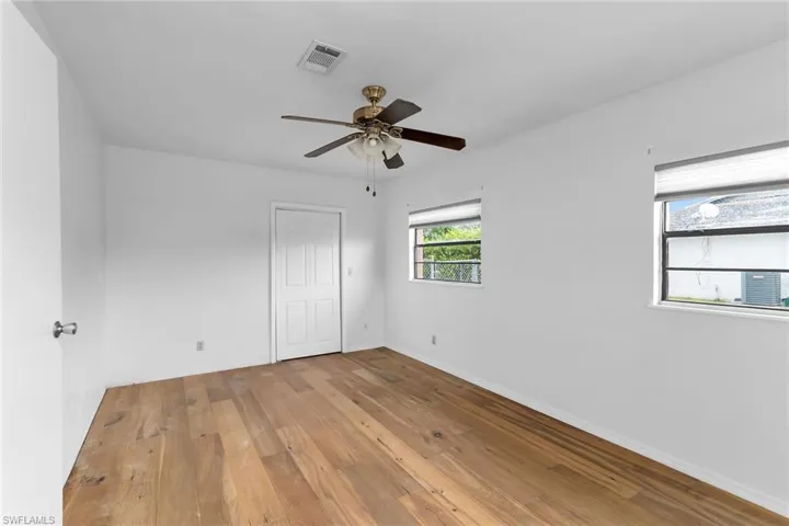 Unfurnished bedroom with light wood-style floors, a ceiling fan, and a closet