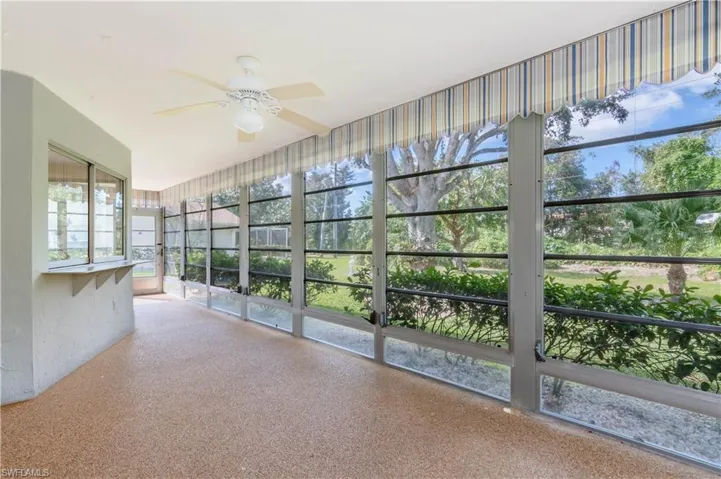 Unfurnished sunroom featuring ceiling fan