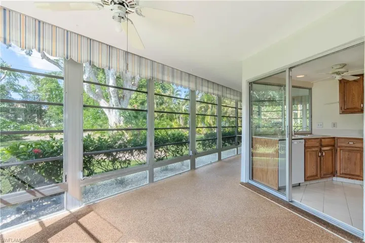 Unfurnished sunroom featuring ceiling fan