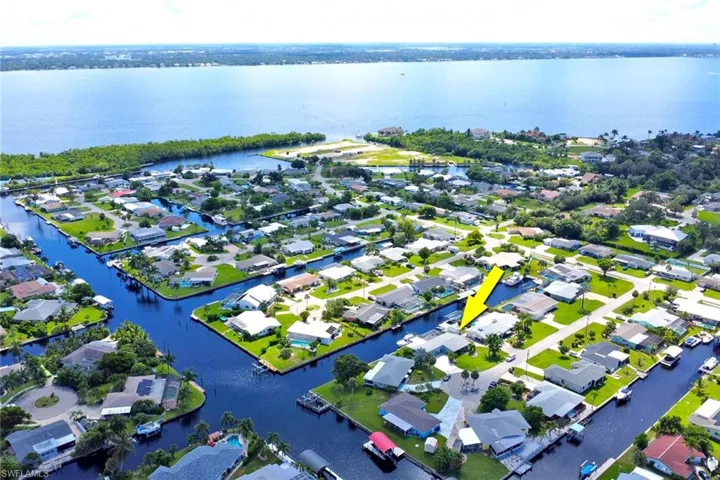 Aerial view of residential area featuring a nearby body of water