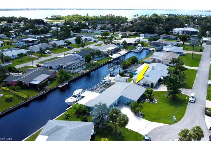 Aerial perspective of suburban area featuring a large body of water