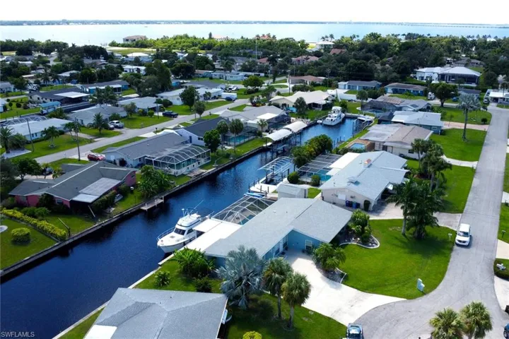 Aerial perspective of suburban area with a nearby body of water
