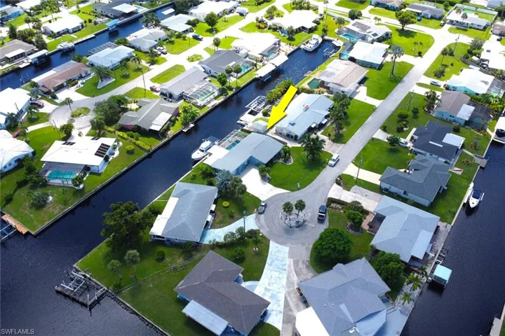 Aerial view of property and surrounding area with nearby suburban area and a nearby body of water