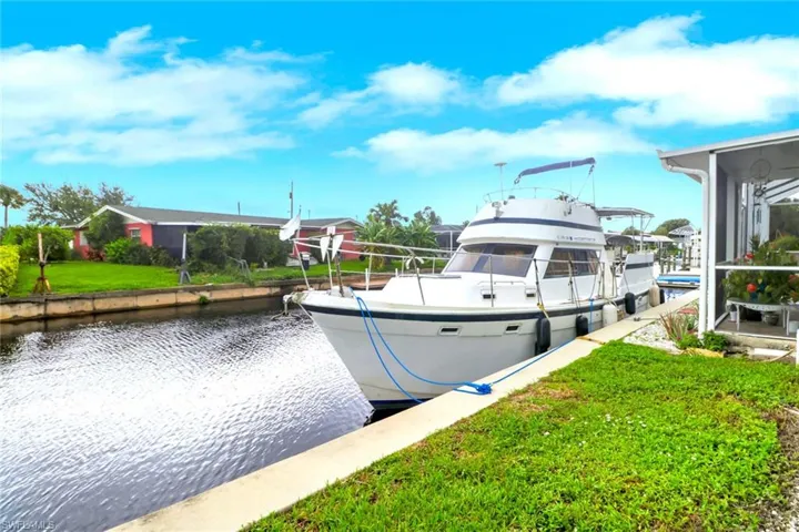 Dock with a water view and a yard