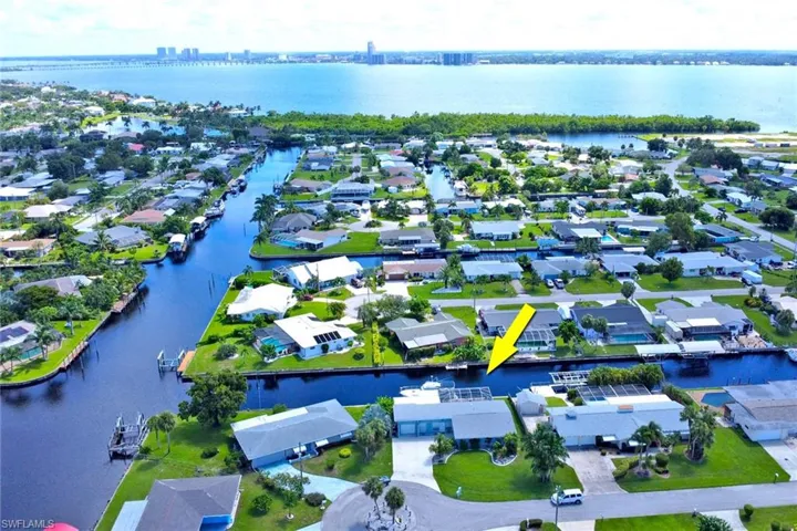 Aerial perspective of suburban area featuring a large body of water