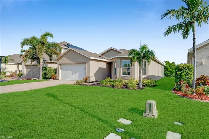 Single-story stucco exterior with an attached garage, bay window, and a concrete driveway