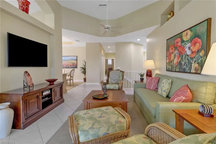 Tiled living room featuring ceiling fan