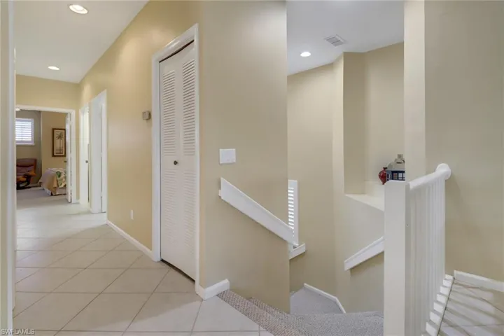 Hallway with light tile patterned flooring