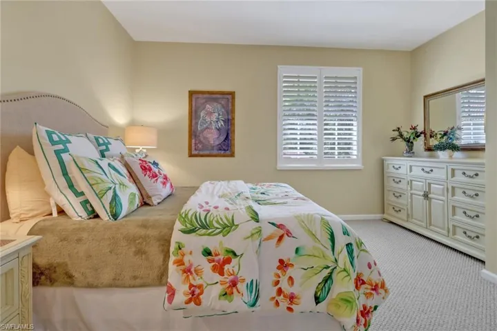 Bedroom featuring light carpet