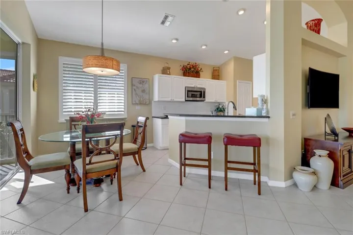 Tiled dining area featuring sink
