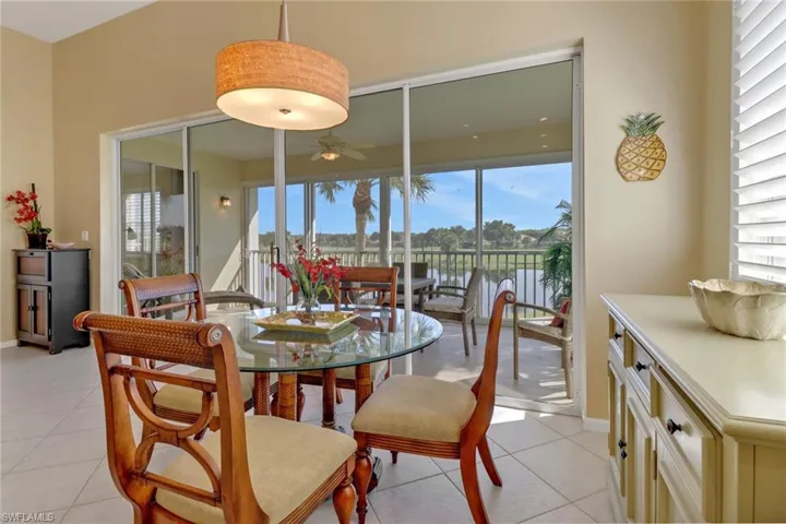 Dining space featuring ceiling fan, light tile patterned flooring, and a healthy amount of sunlight