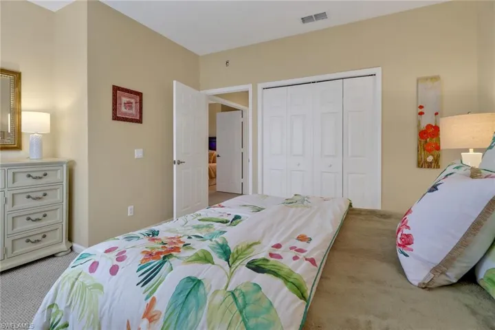 Bedroom with a closet and light carpet