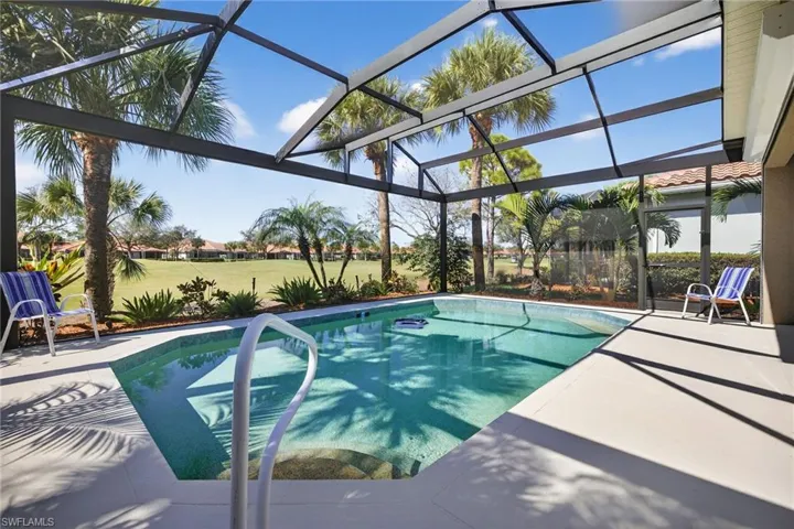 Outdoor pool featuring panoramic Screen  enclosure, a sunroom, and a patio area