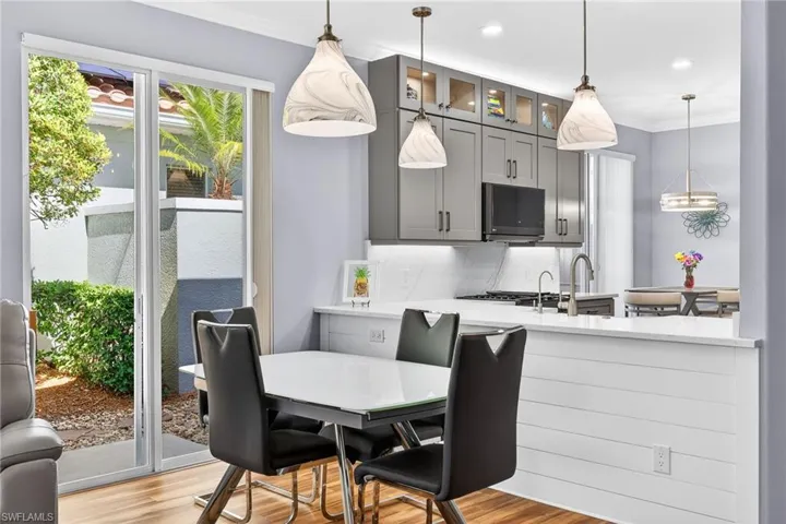 Dining area featuring wood finished floors, ornamental molding, and recessed lighting