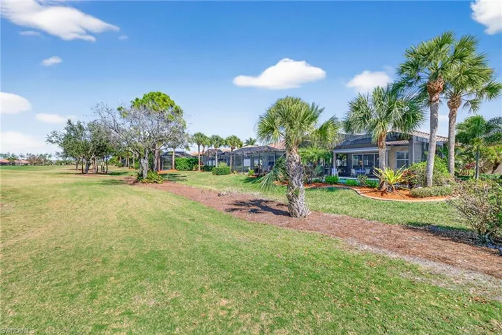 View of green lawn featuring a sunroom