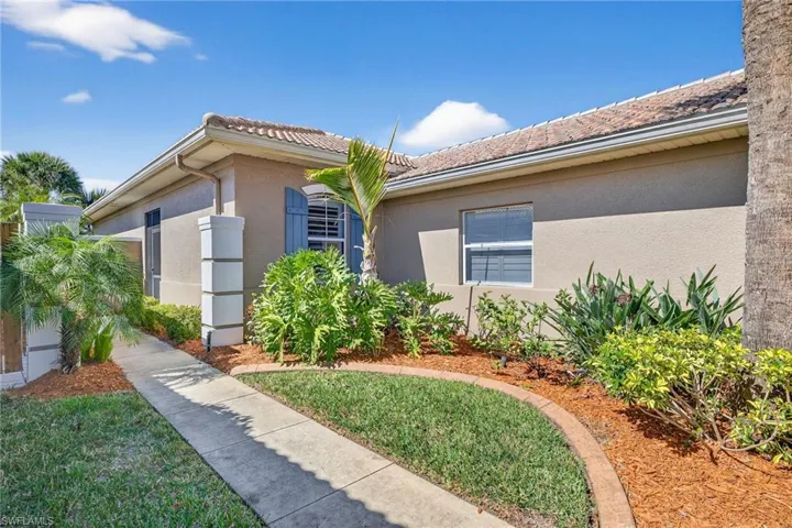 Property entrance with stucco siding and a tile roof