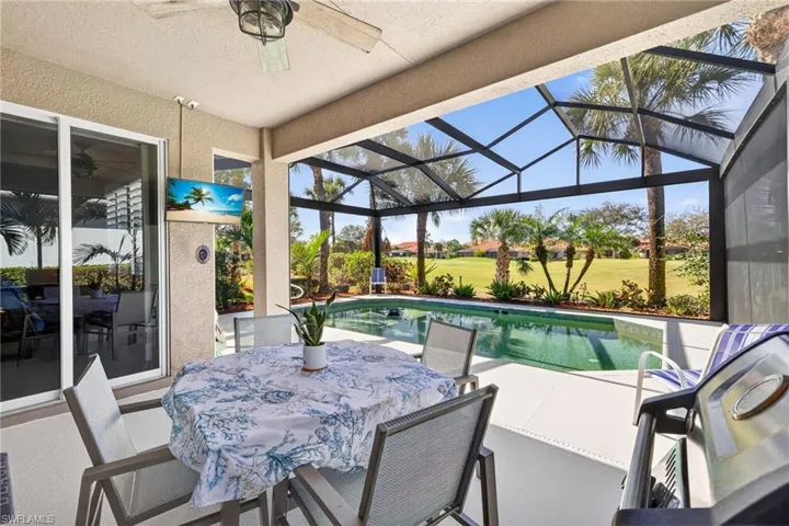 View of patio / terrace with an outdoor pool, outdoor dining space, a sunroom, grilling area, and glass enclosure