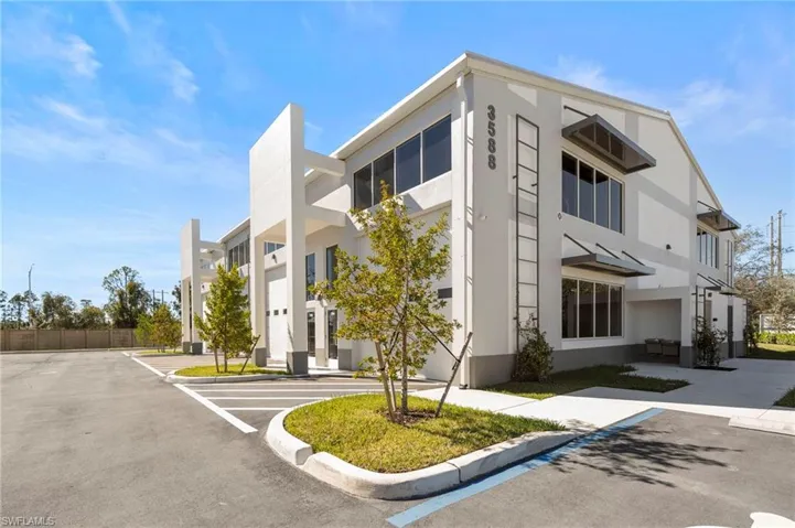 View of property featuring uncovered parking