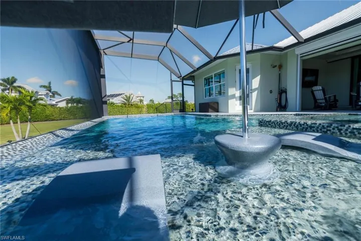 View of swimming pool with a patio area and a lanai