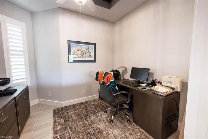 Home office featuring light wood-type flooring and ceiling fan