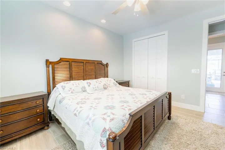 Bedroom with a closet, ceiling fan, and light hardwood / wood-style floors