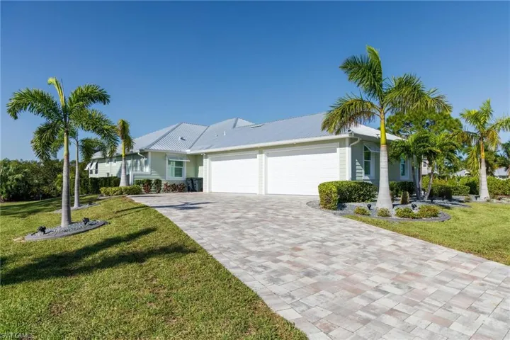 Ranch-style home with a front yard and a garage