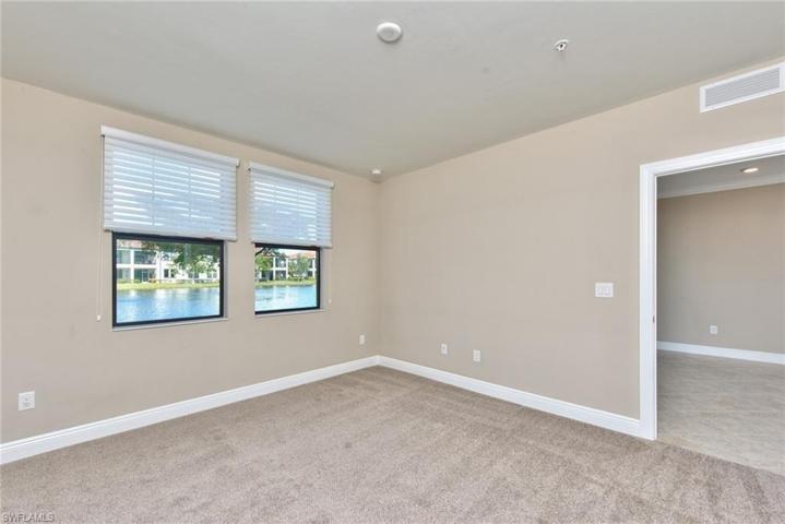 Primary suite with windows overlooking the lake and brand new carpet