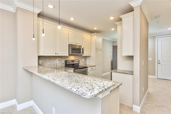 Kitchen with stainless steel appliances, tile backsplash, granite counters