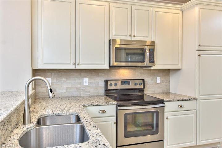 Kitchen with Whirlpool stainless steel appliances, double bowl stainless steel sink, and built in pantry