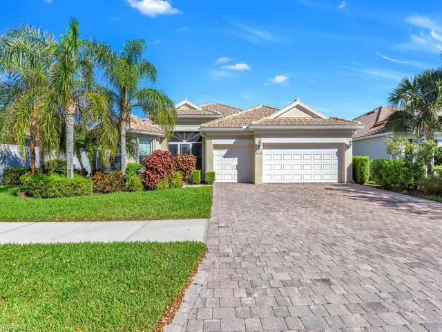 Mediterranean / spanish home with a garage and a front lawn