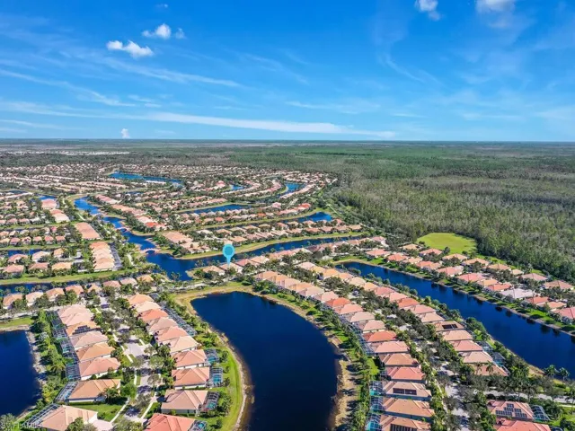 Birds eye view of property with a water view