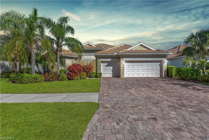 Mediterranean / spanish house featuring a front yard and a garage
