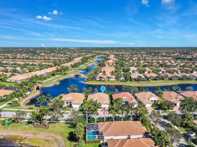 Birds eye view of property with a water view