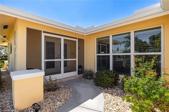 Entrance to property with stucco siding and french doors
