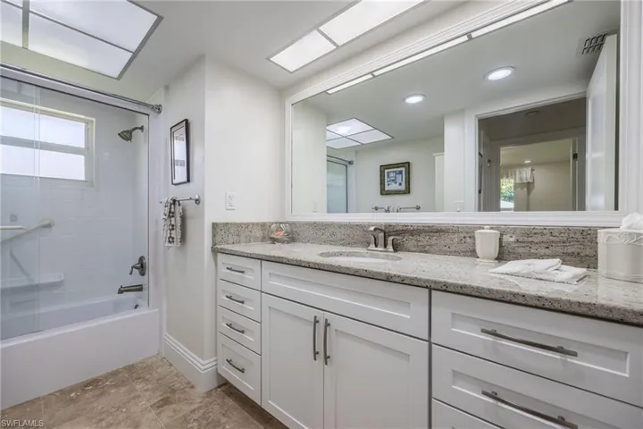 Full bath with vanity, recessed lighting, baseboards, visible vents, and  shower combination