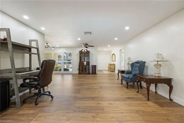 Office featuring recessed lighting, baseboards, ceiling fan, visible vents, and wood finished floors