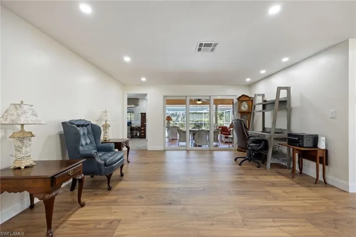 Home office featuring wood finished floors, recessed lighting, baseboards, and visible vents