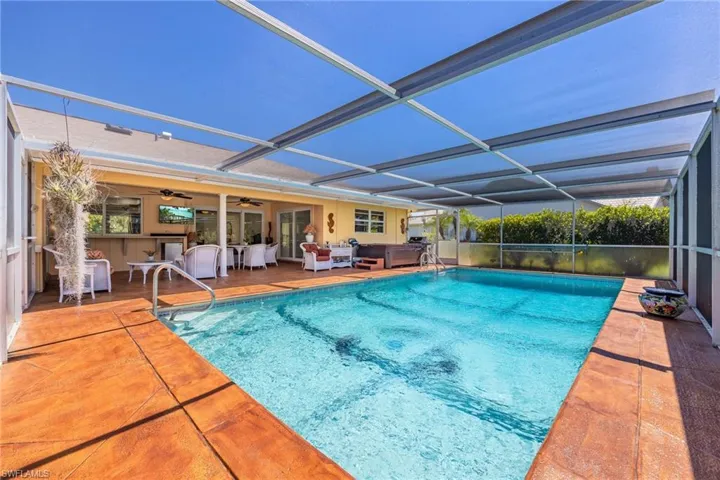 View of swimming pool with an outdoor hangout area, a fenced in pool, glass enclosure, ceiling fan, and a patio area