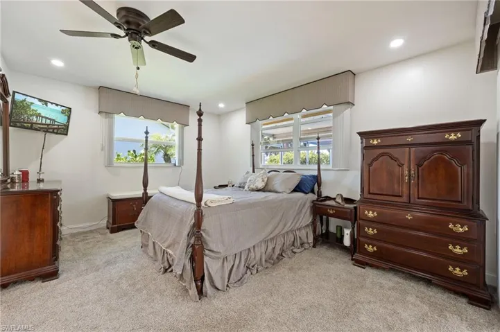Bedroom with light carpet, baseboards, recessed lighting, and a ceiling fan