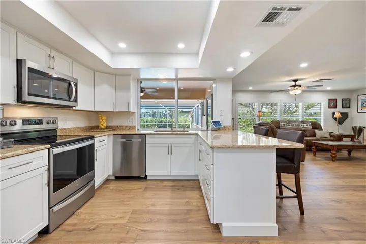 Kitchen featuring visible vents, ceiling fan, appliances with stainless steel finishes, and a peninsula