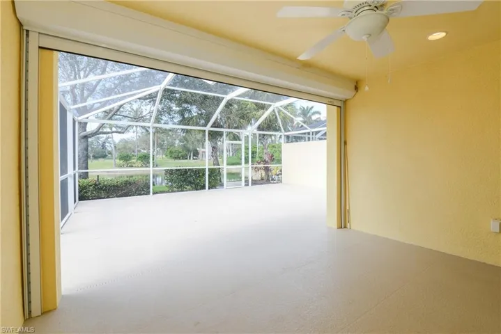View of patio with a lanai and ceiling fan