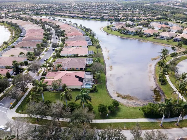 Birds eye view of property with a water view