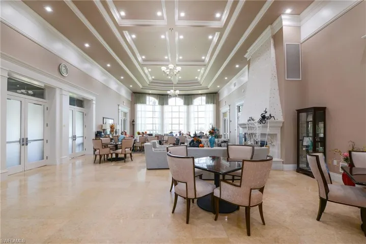 Dining area with french doors, crown molding, and an inviting chandelier