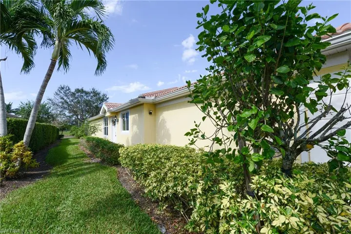 View of side of home with a yard