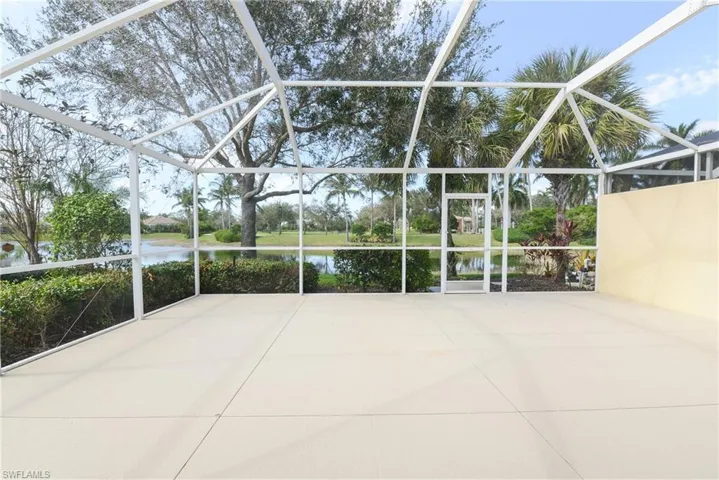 View of patio featuring a lanai and a water view