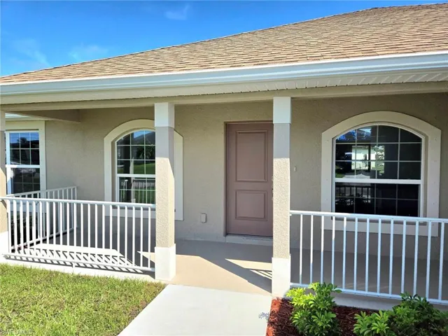 Doorway to property featuring covered porch
