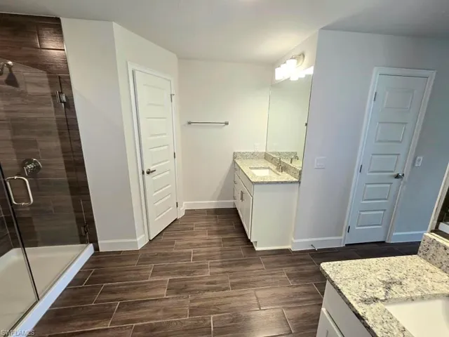 Bathroom with a shower with door and vanity